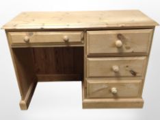 A contemporary pine single-pedestal desk fitted four drawers, 107cm wide x 44cm deep x 75cm high.