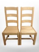 A contemporary set of six oak ladder back dining chairs