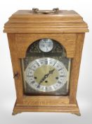 A reproduction Tempus Fugit bracket clock in oak case, height 42cm.