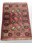 A Bokhara design rug on red ground, 147cm x 103cm.