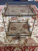 A gilt metal and glass two-tier occasional table, height 61cm.
