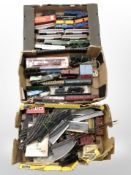 A collection of OO gauge locomotives and passenger cars, track, railway building components, etc.