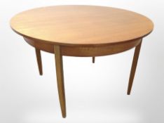 A 20th-century teak circular extending dining table, diameter 122cm (unextended),