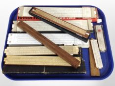 A group of slide rules, folding rules, etc., some boxed.