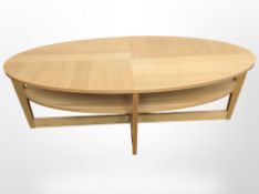 An oak veneered oval two-tier coffee table,