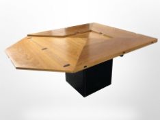 A contemporary Scandinavian envelope extending square pedestal dining table,