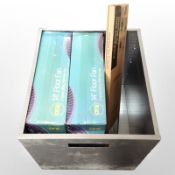 A square galvanised planter containing two boxed 14-inch floor fans and a further extra-slim TV