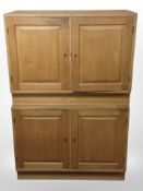 A pair of 20th-century Danish blonde oak double-door cabinets, each 90cm wide.