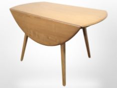 An Ercol elm and beech drop-leaf extending dining table, length 112cm.