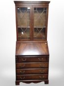 A reproduction mahogany bureau bookcase, 77cm wide x 47cm deep x 187cm high.