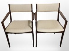 A pair of contemporary Danish teak-framed armchairs in beige upholstery.