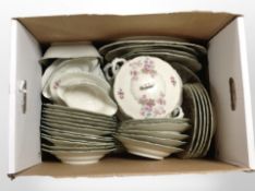 A collection of German dinner porcelain decorated with floral blossoms.