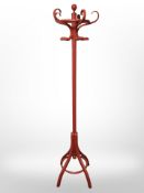 A red-painted hat and coat stand, height 189cm.