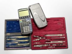 A Texas Instruments draughtsmen's calculator, together with two cased sets of drawing instruments,