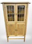 A Danish blonde oak leaded-glass double-door corner cabinet, height 140cm.