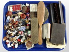 A group of vintage postcards, dressing table brushes, pens, assorted miniature figurines, etc.