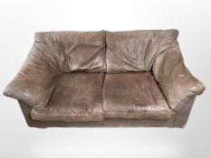 A 20th-century brown leather two-seater settee, width 164cm. CONDITION REPORT: Faded.