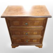 A reproduction mahogany three-drawer bedside chest, width 50cm.