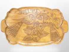 A Scandinavian carved teak twin-handled serving tray depicting birds, width 68cm.