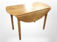 A pine drop-leaf dining table, length 110cm.