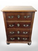 A 19th-century continental mahogany and pine four-drawer chest on bun feet,