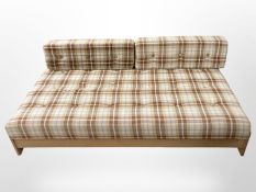 A 20th-century Danish bed settee in checkered fabric, width 196cm.