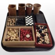 A quantity of stained boxwood chess pieces, dice and dice cups.