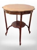 A mahogany two-tier occasional table on brass castors, height 70cm.