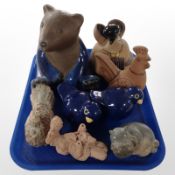 A group of continental earthenware animal ornaments including large figure of a seated bear,