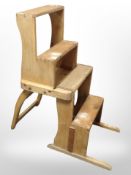An early-20th century folding pine metamorphic library step chair.
