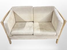 A 20th-century cream suede two-seater settee, width 138cm.