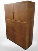 A 20th-century Danish teak four-door office cabinet fitted sliding shelves to upper section,