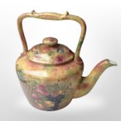 A large transfer-printed teapot decorated with fruit, height 30cm.