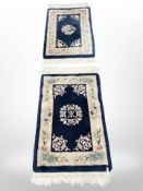 Two Chinese rugs on blue ground, largest 112cm x 62cm.