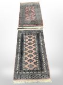 Two Lahore Bokhara rugs on pink ground, largest 141cm x 79cm, and signed to one end.