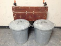 A Workmate folding work bench and two galvanised bins.