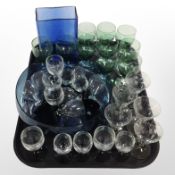 A quantity of etched crystal drinking glasses, blue brick vase and a fruit bowl.