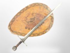 A fantasy sword, together with a painted shield depicting a Native American.