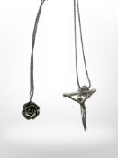 A contemporary silver crucifix pendant on chain and a further rose pendant.