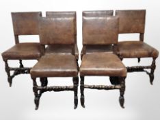 A set of six 19th-century carved oak dining chairs, upholstered in brown leather.