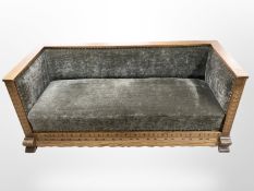 An Edwardian continental oak three-seater settee, width 179cm.