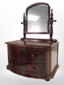 A reproduction mahogany bow-front dressing table mirror, width 38cm.