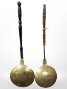 Two 19th-century copper and brass bed-warming pans.