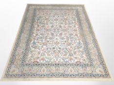 A machine-made rug of Persian design, 196cm x 137cm.