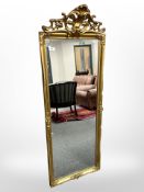 An early-20th century gilded wooden mirror, 50cm x 138cm.