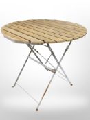 A circular folding patio table, diameter 77cm.