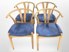 Four Danish Wegner-style armchairs in blue upholstery.