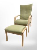 A Danish beech armchair upholstered in green fabric, with matching footstool.