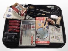 A group of Swiss Army knives, playing cards, corkscrew, Zippo lighter, stamps, pair of binoculars,