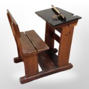 An early-20th century pine child's school desk, width 57cm.